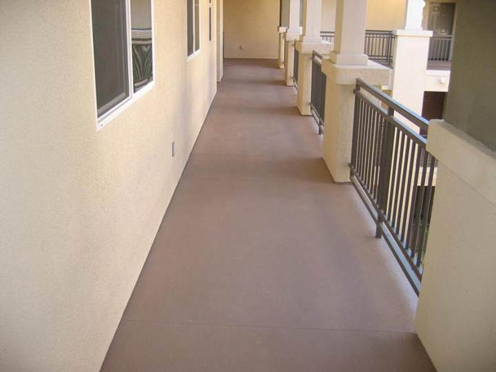 Exterior apartment walkway coated with a waterproofing industrial coating