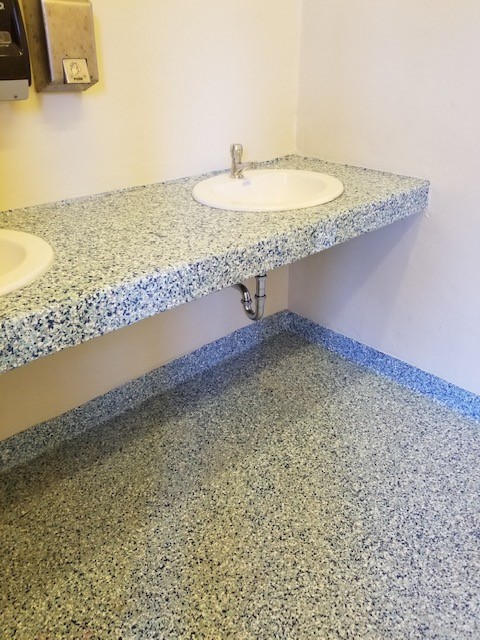 Public restroom floor coated with Primetech 21, full broadcast of vinyl chips and Protech 7072SC topcoat